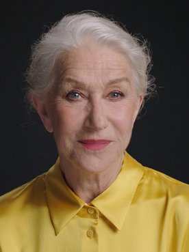 Portrait photo of Helen Mirren in front of black background.