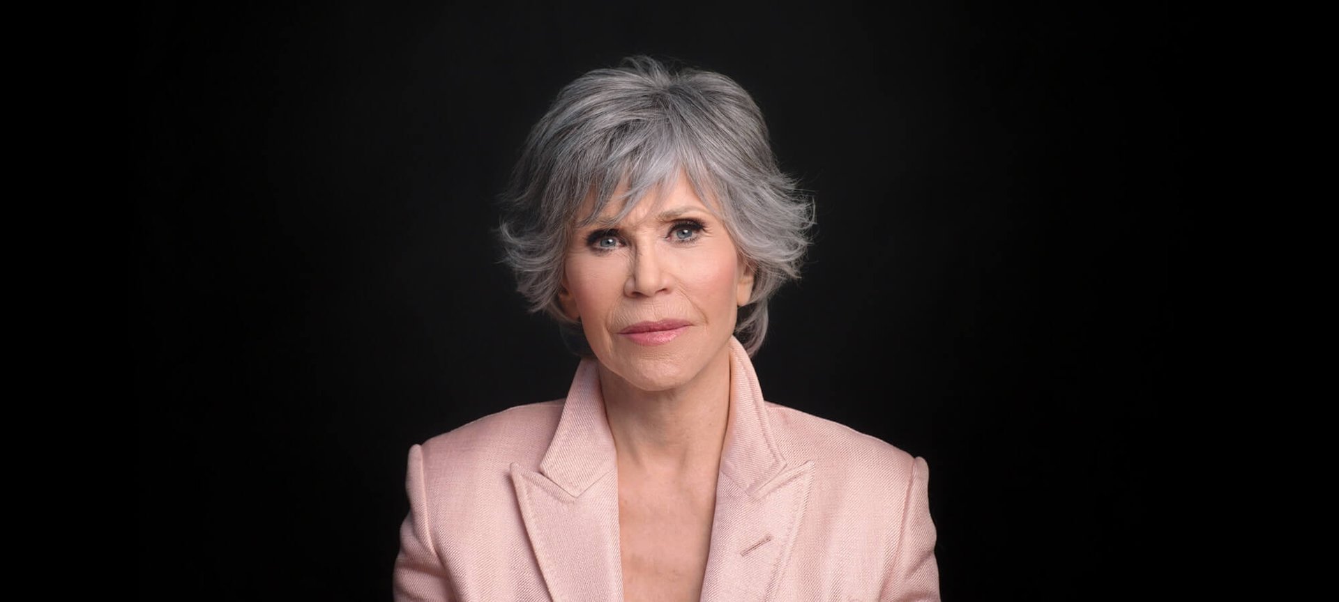 Portrait photo of Jane in front of black background.