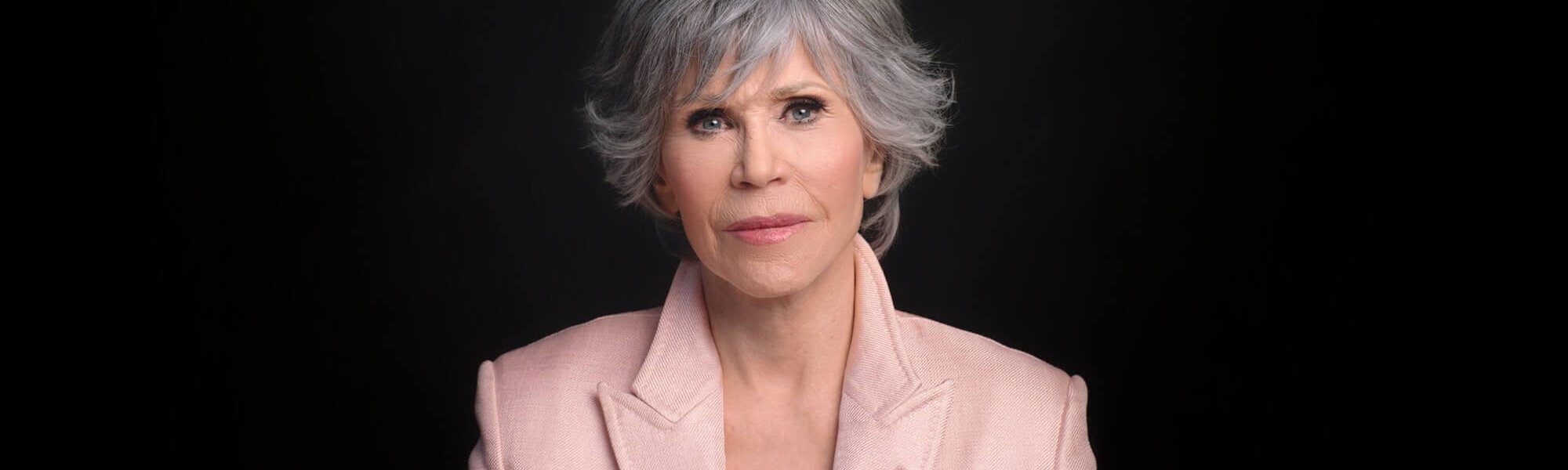 Portrait photo of Jane in front of black background.