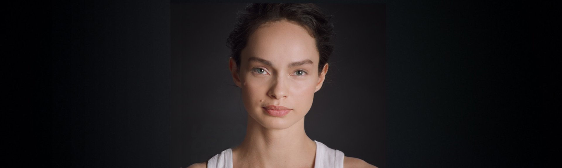 Portrait photo of Luma Grothe in front of black background.