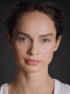 Portrait photo of Luma Grothe in front of black background.