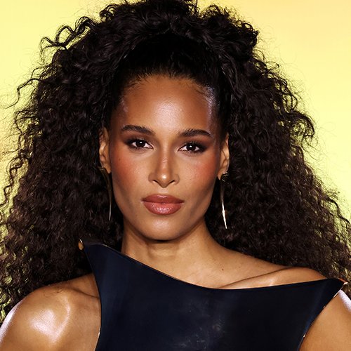 Cindy Bruna wearing the bronzed Glow Gold Glam Core look with peachy blush, rich eyeshadow and a nude lip.