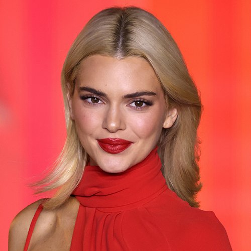 Kendall Jenner wearing the elegant Pure Demure Core look with a subtle blush, glamourous lashes and red lipstick.